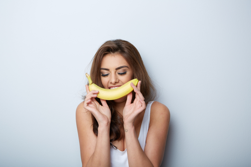 woman making fun with a banana
